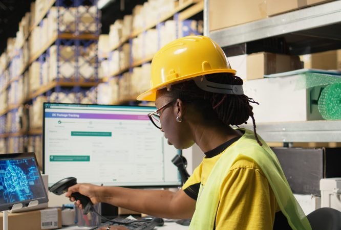 Woman uses AI-generated software for order processing automation, advanced neural networks cloud computing system ensures parcel tracking with a computer in warehouse with racks. Camera A.